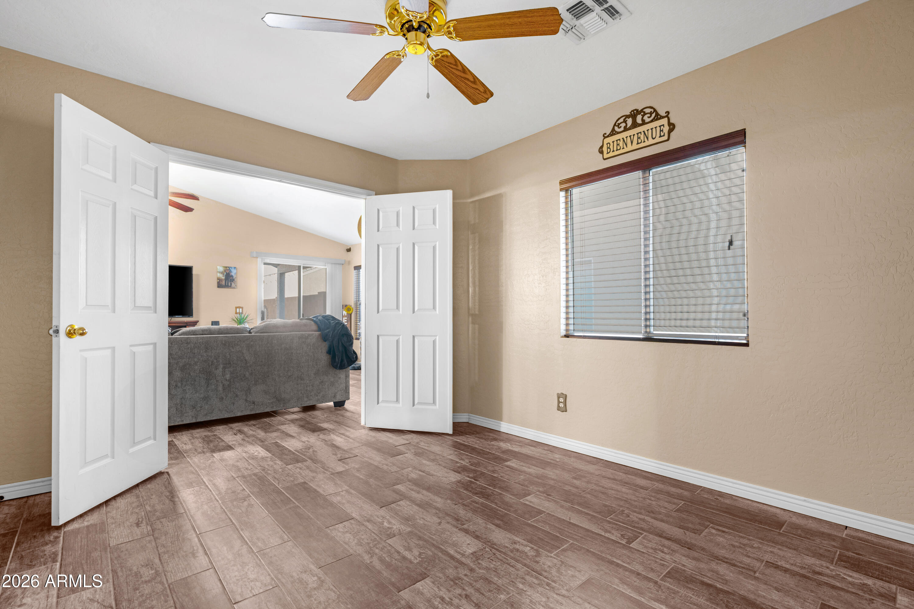 12018 West Almeria Road Avondale, AZ 85392 - Photo 20 of 39 a view of a bedroom with wooden floor and windows