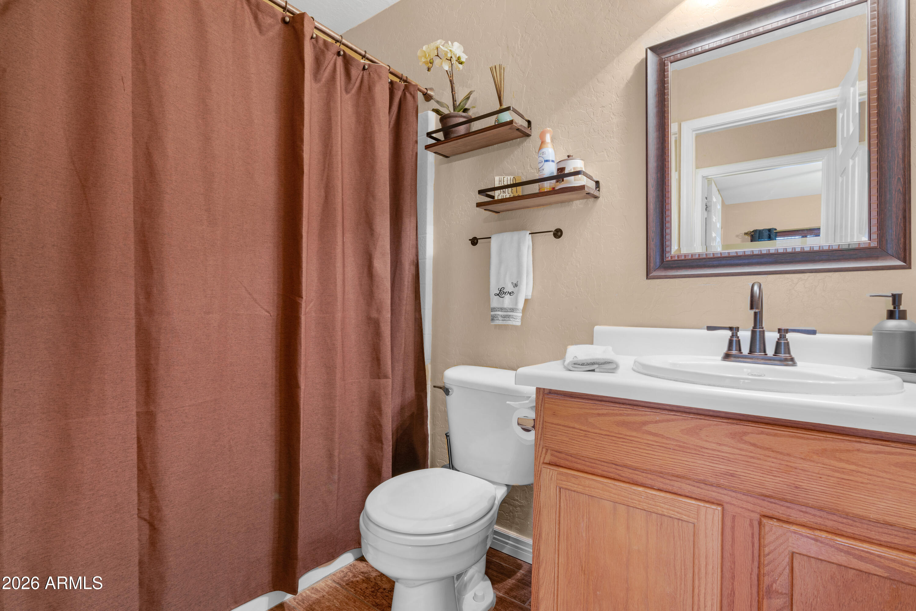 12018 West Almeria Road Avondale, AZ 85392 - Photo 26 of 39 a bathroom with a granite countertop sink toilet and mirror