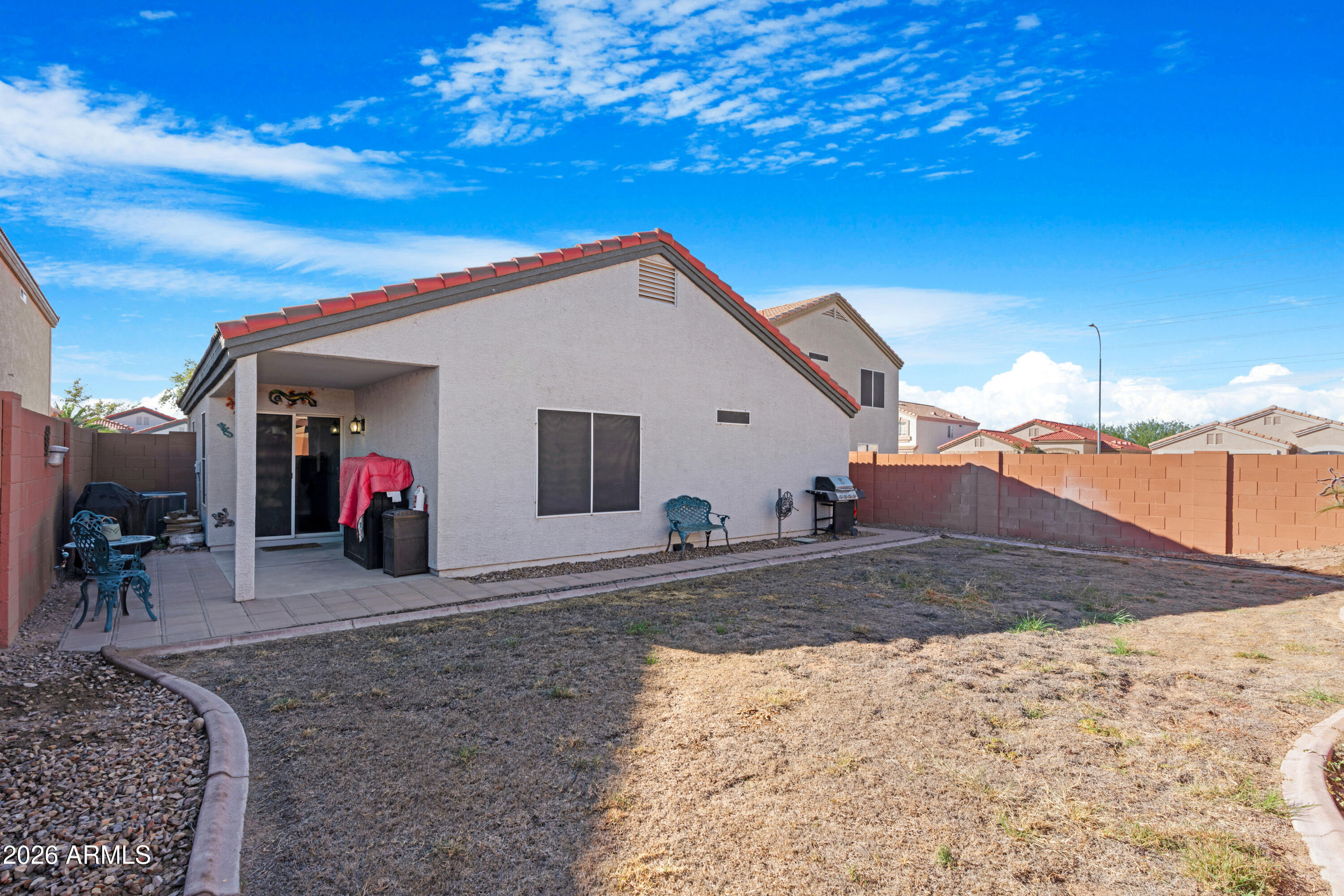 12018 West Almeria Road Avondale, AZ 85392 - Photo 28 of 39 a view of a house with a patio