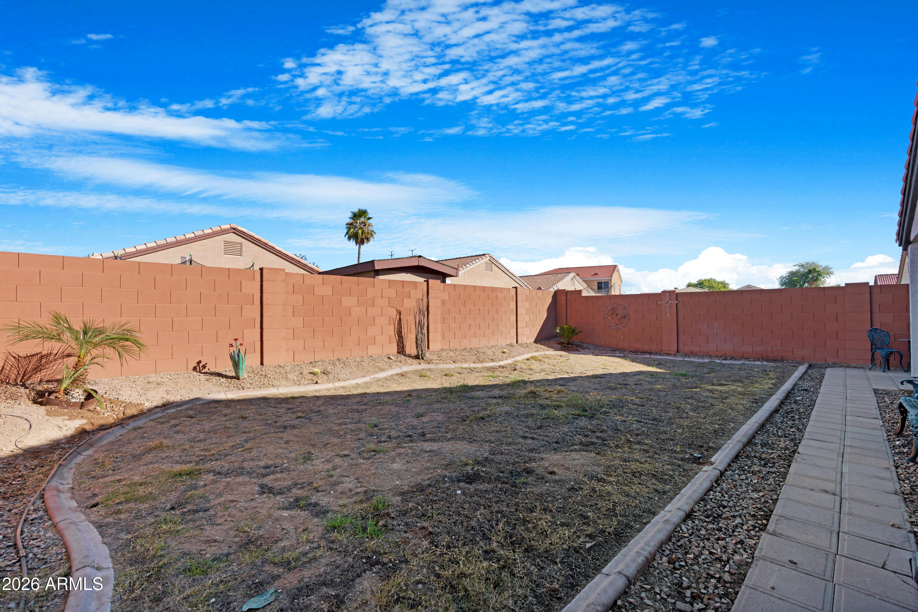12018 West Almeria Road Avondale, AZ 85392 - Photo 30 of 39 a view of a dry yard with wooden fence