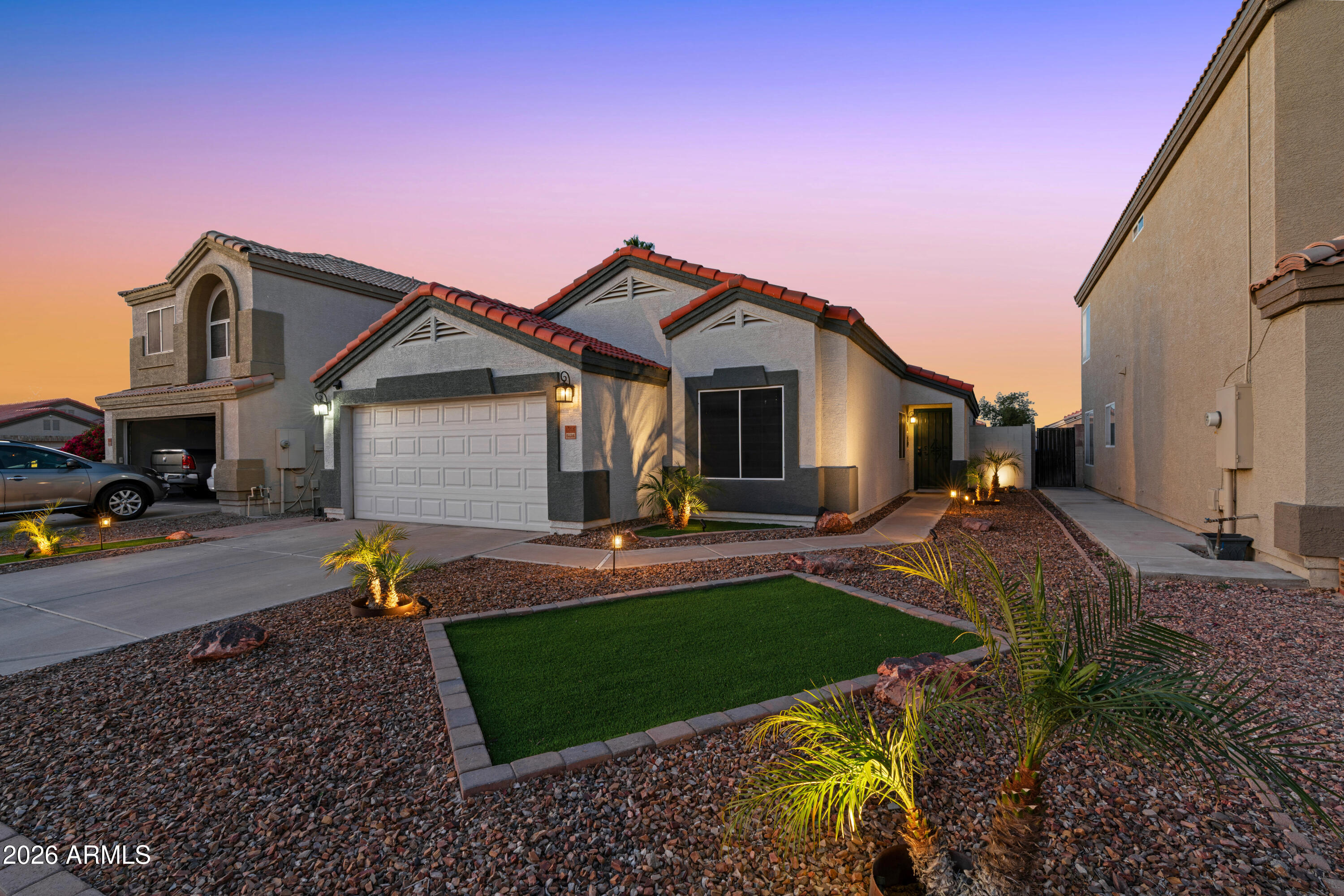 12018 West Almeria Road Avondale, AZ 85392 - Photo 33 of 39 a front view of a house with garden