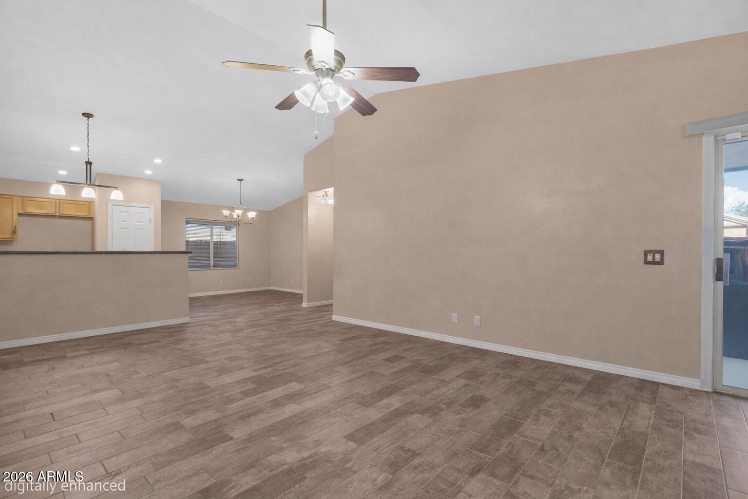 12018 West Almeria Road Avondale, AZ 85392 - Photo 5 of 39 a view of a kitchen with a dishwasher cabinets and a wooden floor