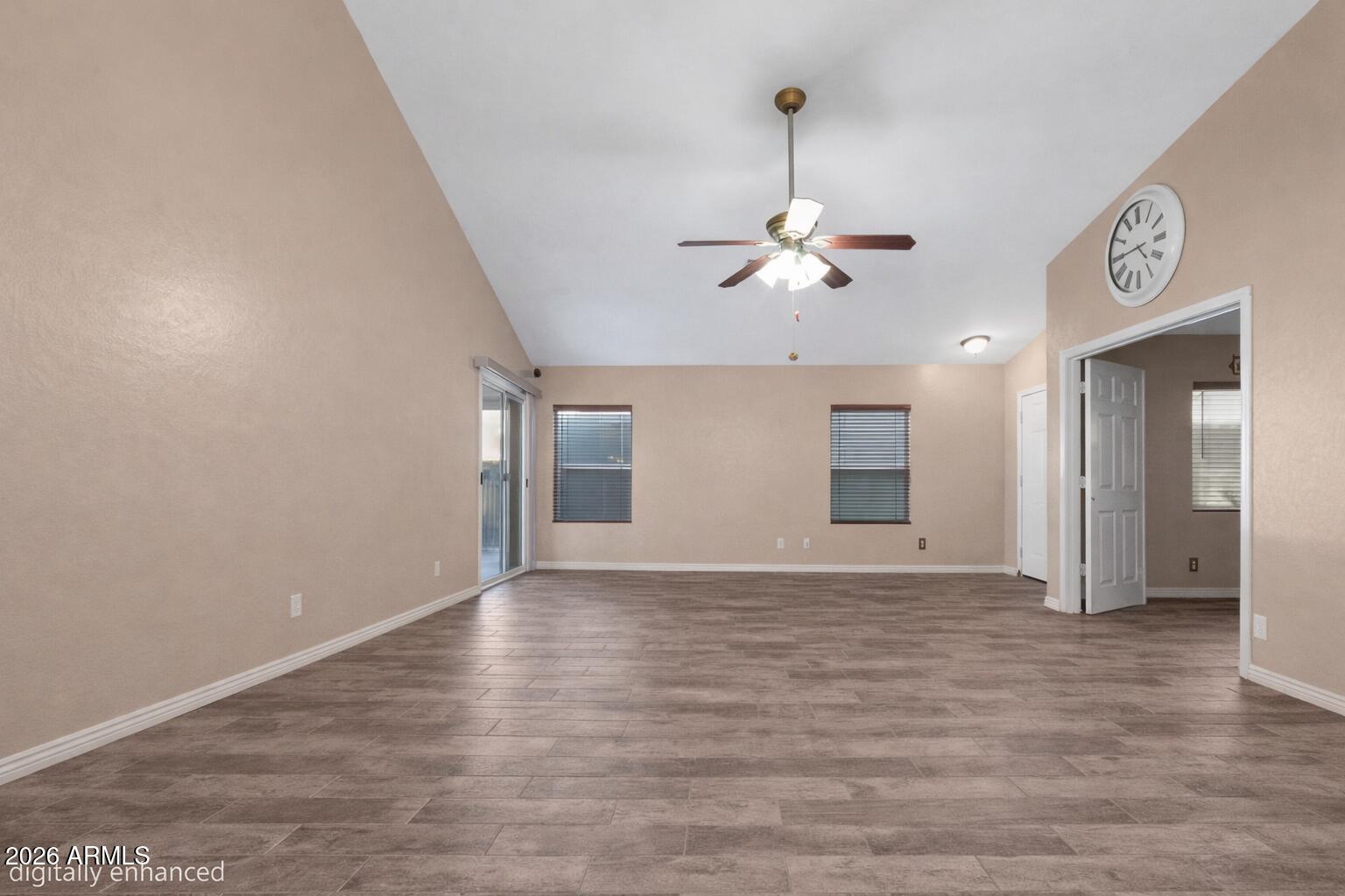 12018 West Almeria Road Avondale, AZ 85392 - Photo 6 of 39 a view of an empty room with glass door