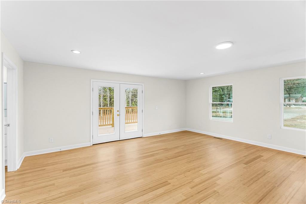 4713 Highway 87 Graham, NC 27253 - Photo 13 of 32 Another View of Spacious Family Room/Primary Suite with Entrance of Double Doors to Side Deck