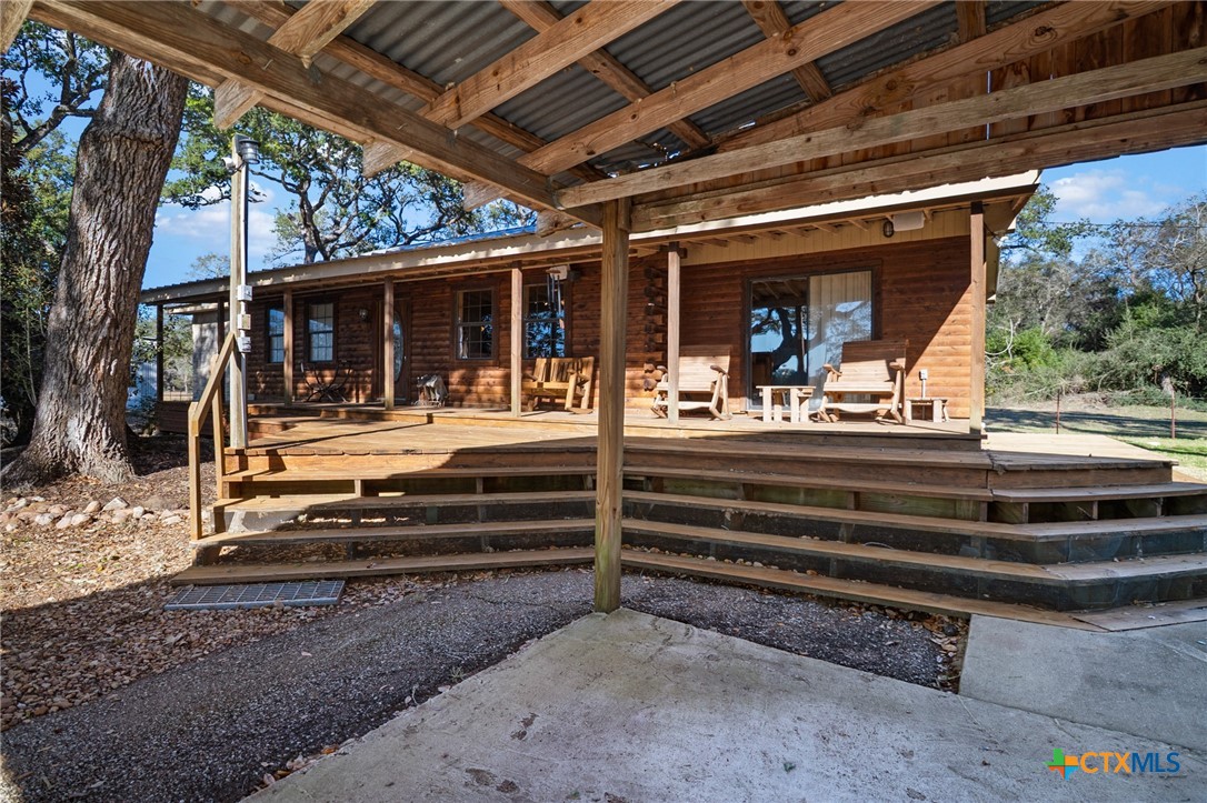 1465 County Road 401 Edna, TX 77957 - Photo 7 of 46 a view of backyard with large trees and a wooden fence