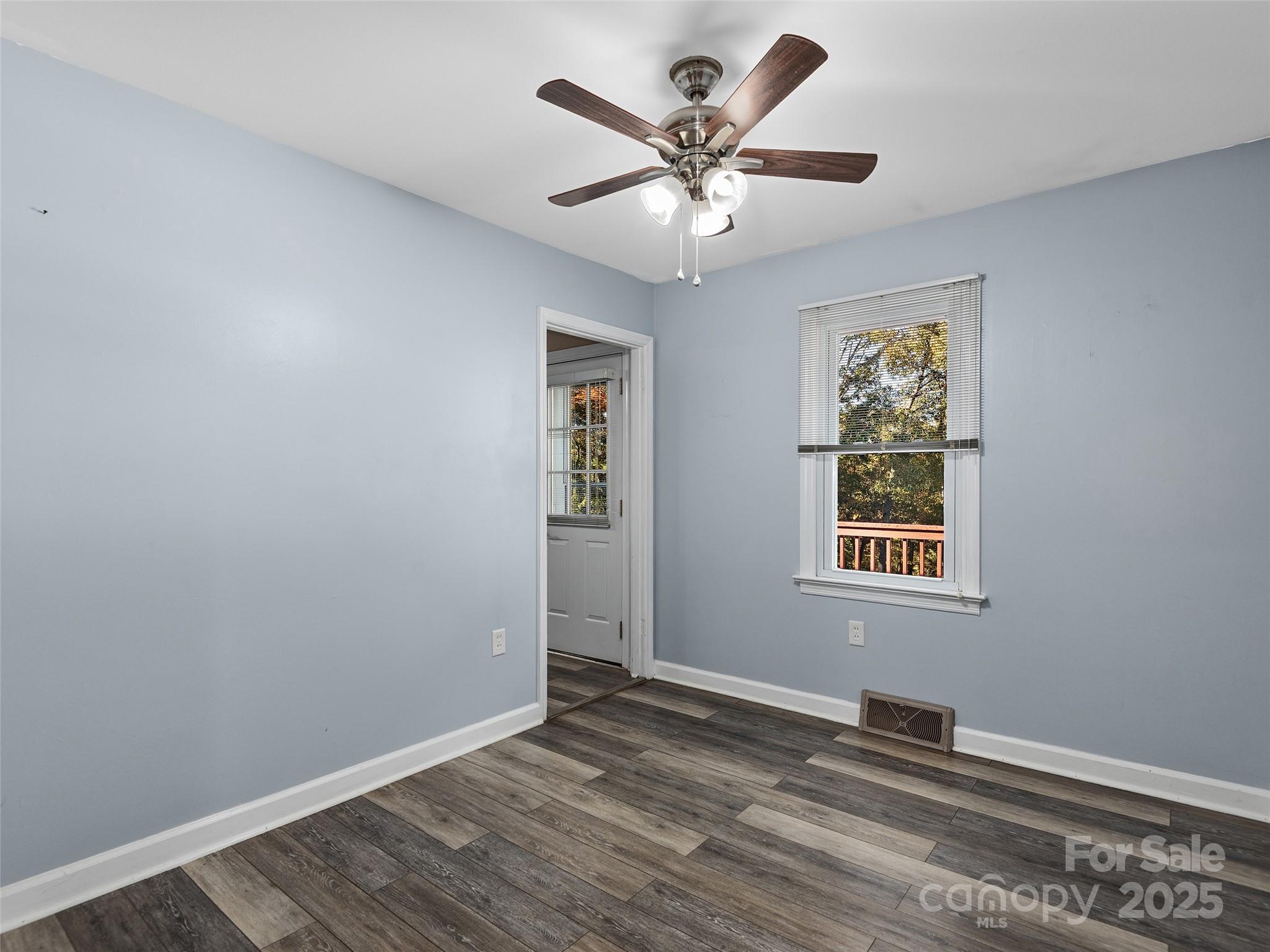 1005 Hutch Mountain Road Fletcher, NC 28732 - Photo 12 of 20 a view of a big room with wooden floor and windows