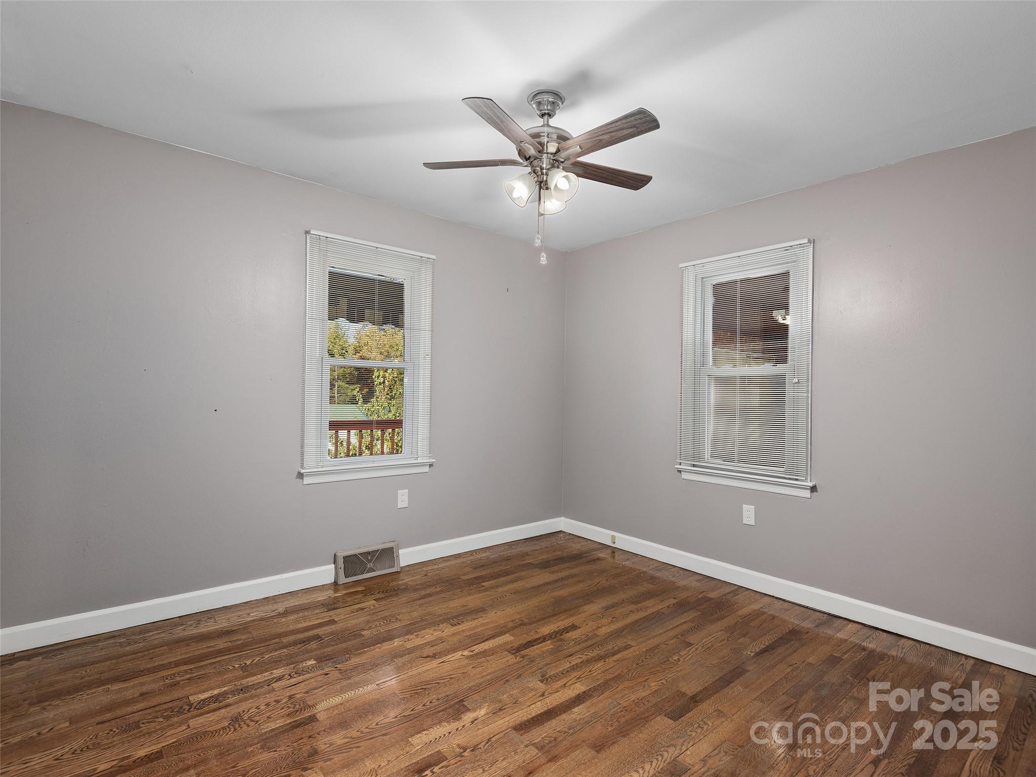 1005 Hutch Mountain Road Fletcher, NC 28732 - Photo 13 of 20 a view of an empty room with wooden floor and a window