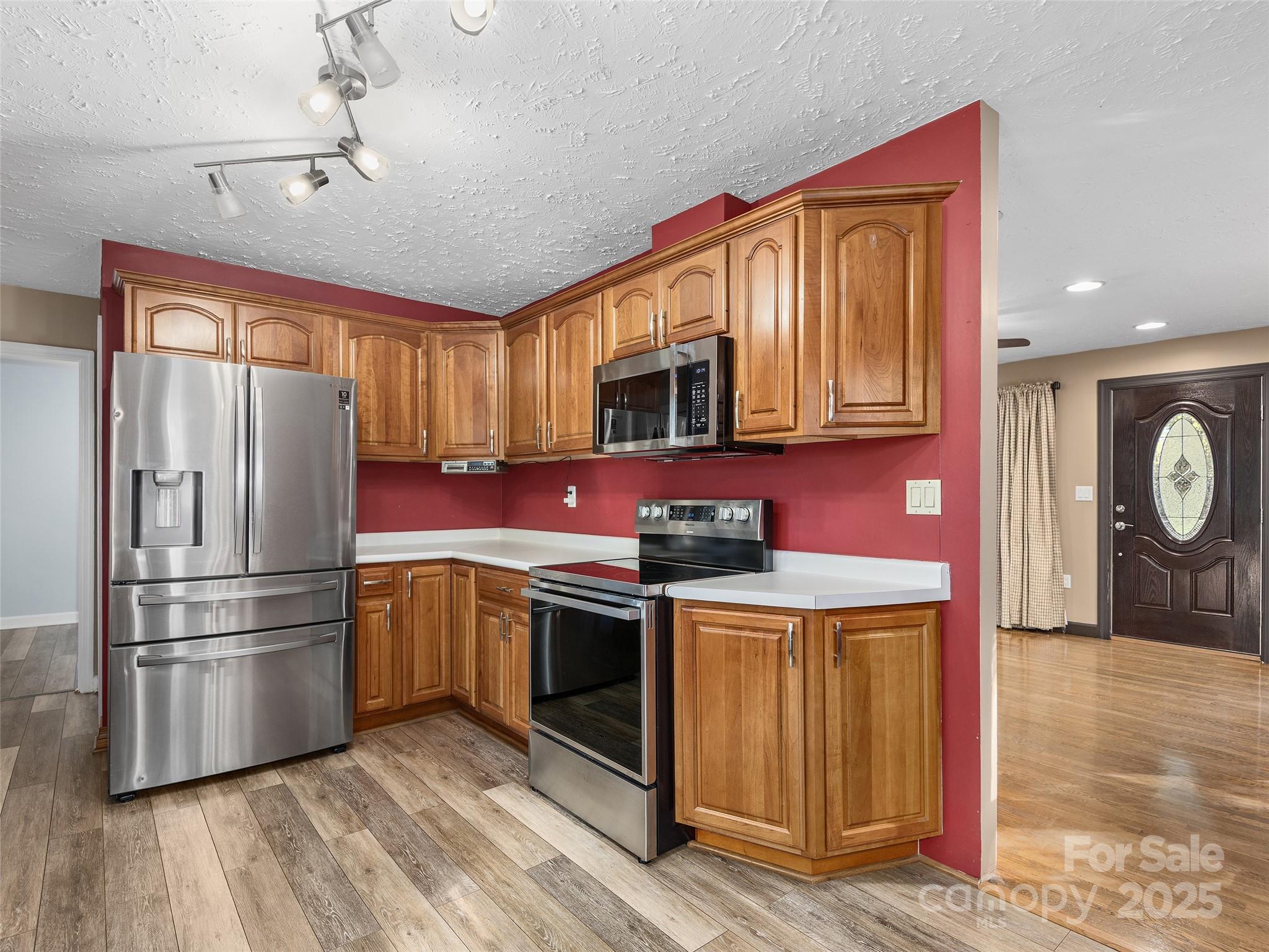 1005 Hutch Mountain Road Fletcher, NC 28732 - Photo 7 of 20 a kitchen with stainless steel appliances granite countertop a refrigerator a stove top oven a sink and dishwasher