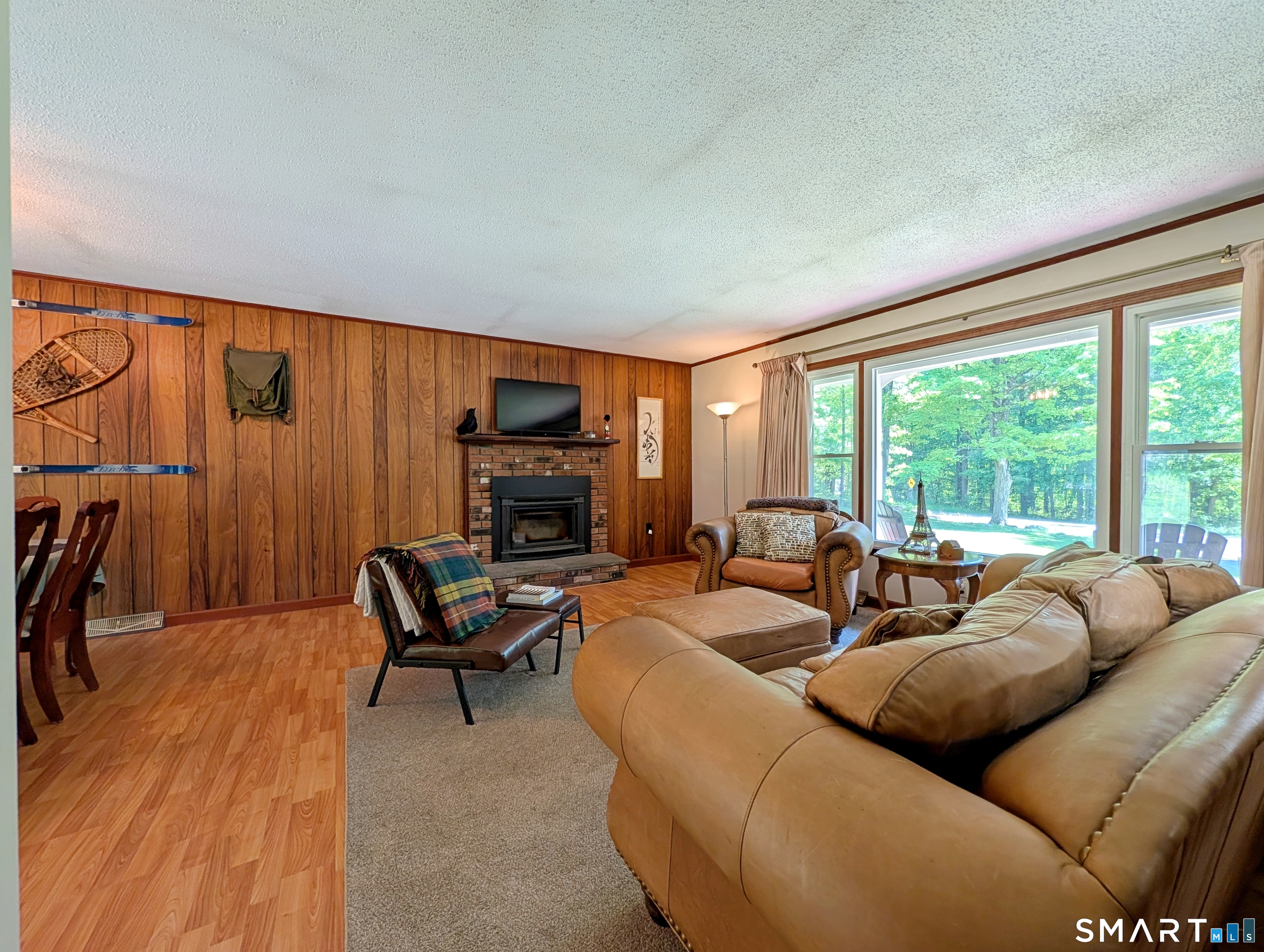 17 Colebrook Road Norfolk, CT 06058 - Photo 10 of 21 a living room with furniture a large window and a flat screen tv