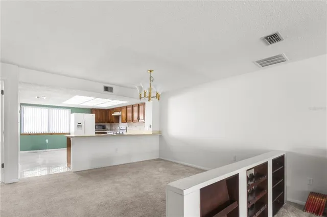 a view of a kitchen with a sink and a window