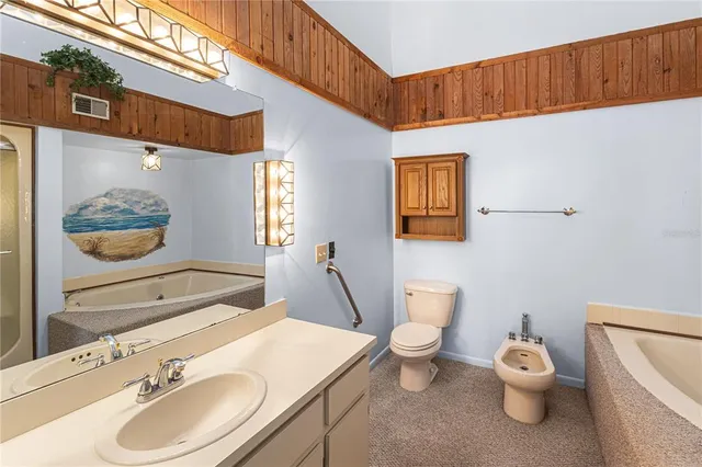 a bathroom with a toilet a sink and a mirror