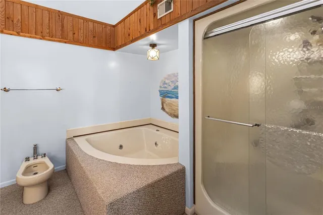 a bathroom with a tub and shower