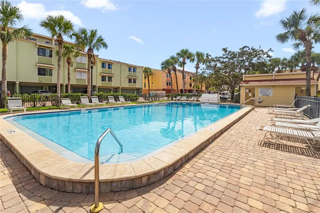 a view of a swimming pool with a lounge chairs