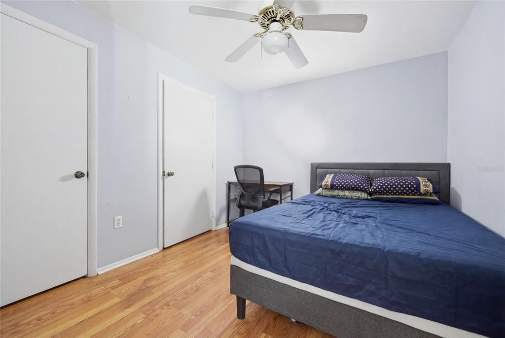 4000 Unit, Unit 3108 Gainesville, FL 32608 - Photo 14 of 20 a bedroom with a bed and wooden floor