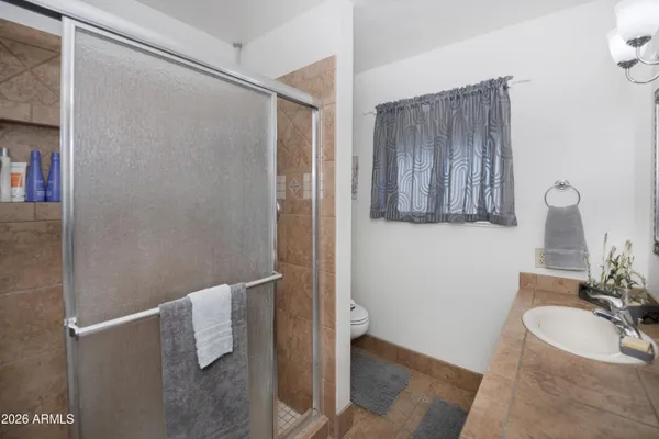 a bedroom with a bed and a potted plant