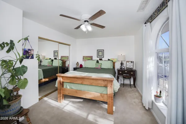 a bedroom with a bed and ceiling fan