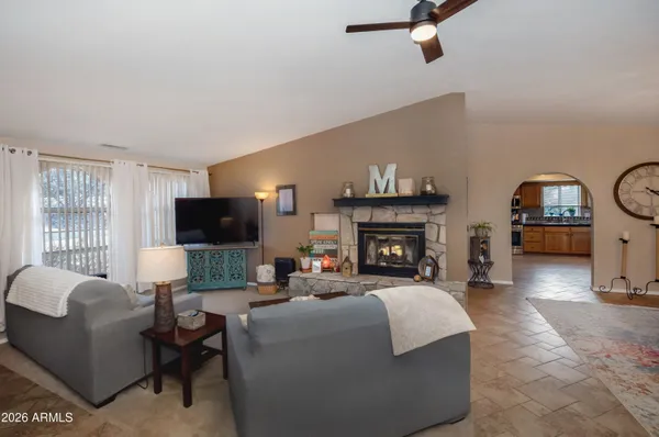 a living room with furniture a fireplace and a flat screen tv