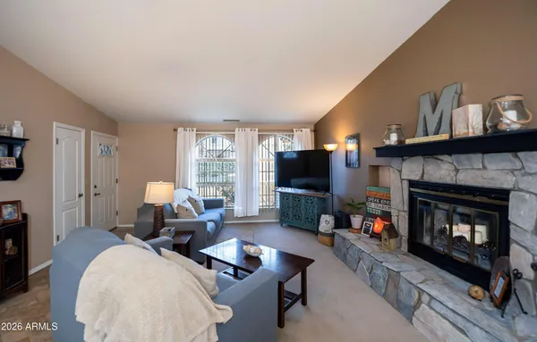 a living room with furniture a flat screen tv and a fireplace