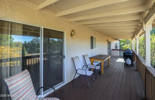 a view of a house with pool and chairs