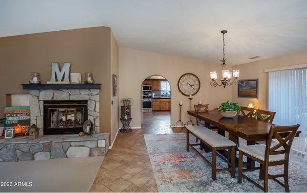 a living room with furniture a fireplace and a chandelier
