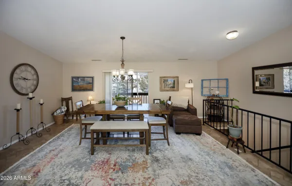 a living room with furniture a chandelier and a window