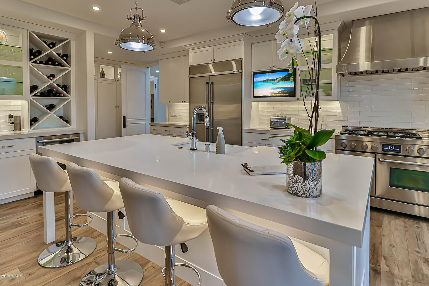 22457 North Summit Ridge Circle Chatsworth, CA 91311 - Photo 13 of 63 a dining room with wooden floor and chandelier