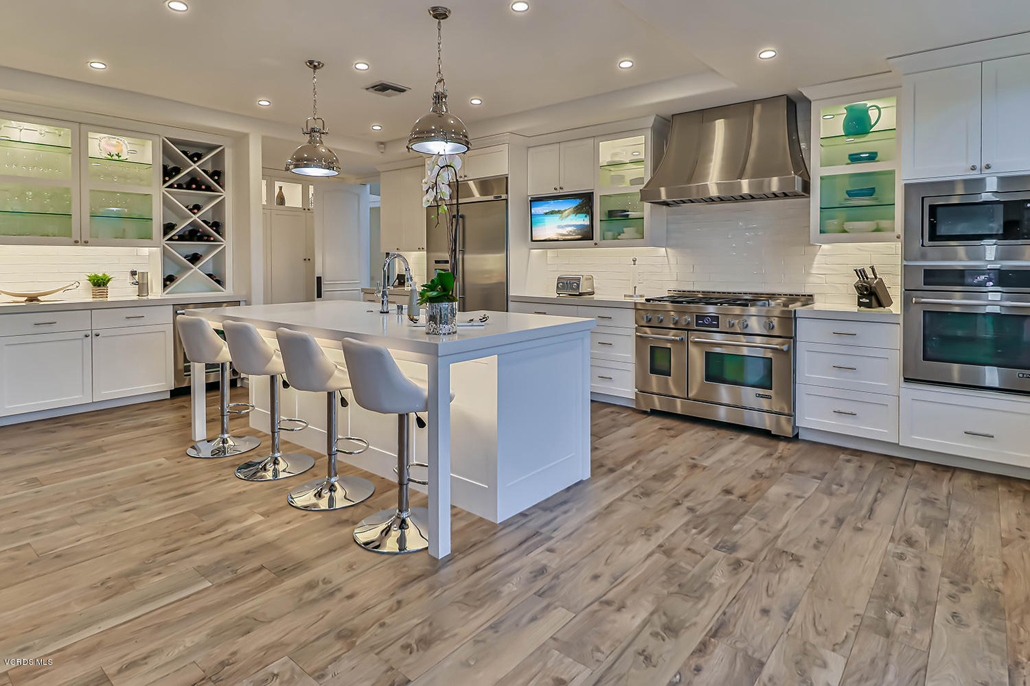 22457 North Summit Ridge Circle Chatsworth, CA 91311 - Photo 14 of 63 a kitchen with stainless steel appliances granite countertop a stove a sink a refrigerator and a microwave