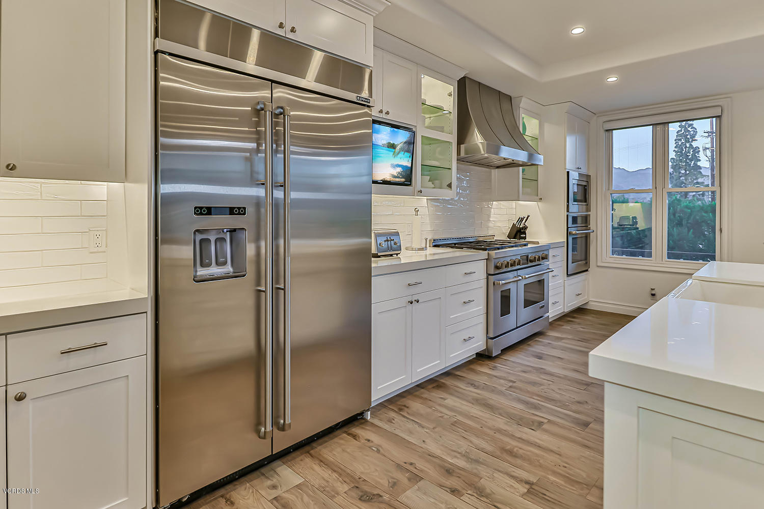 22457 North Summit Ridge Circle Chatsworth, CA 91311 - Photo 15 of 63 a kitchen with stainless steel appliances a refrigerator sink and cabinets