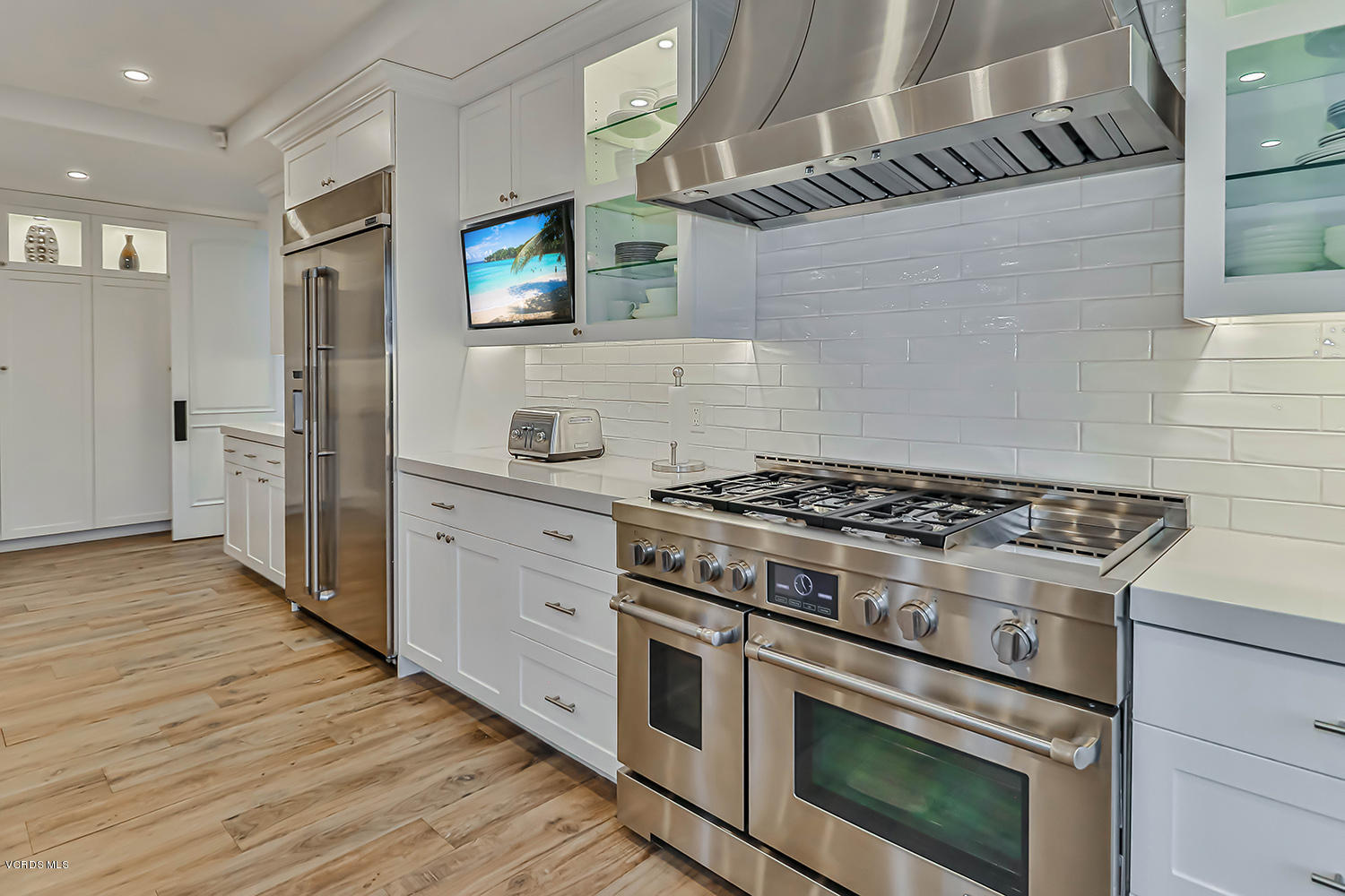22457 North Summit Ridge Circle Chatsworth, CA 91311 - Photo 18 of 63 a kitchen with stainless steel appliances a stove a sink and a refrigerator