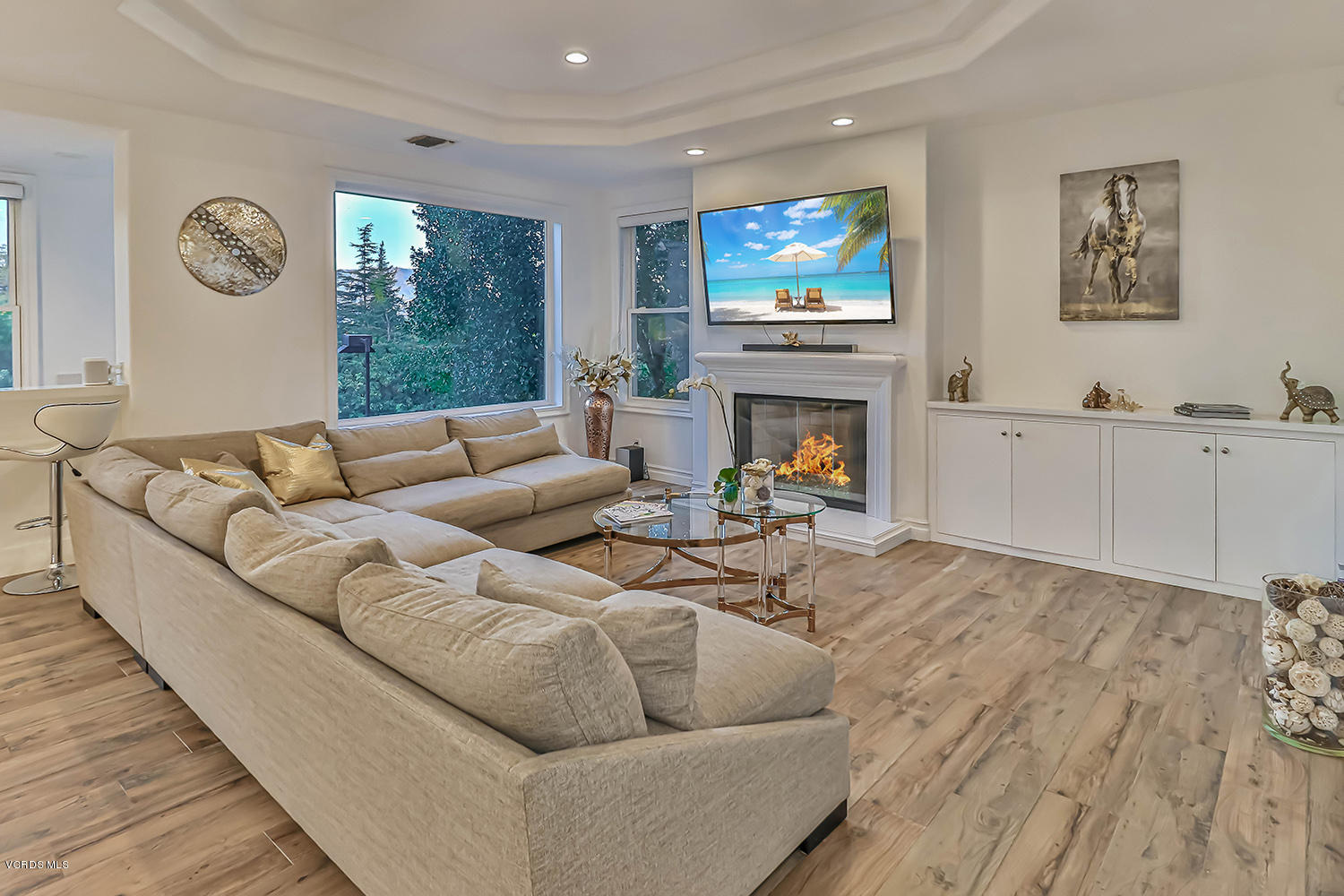22457 North Summit Ridge Circle Chatsworth, CA 91311 - Photo 23 of 63 a living room with furniture a fireplace and a flat screen tv