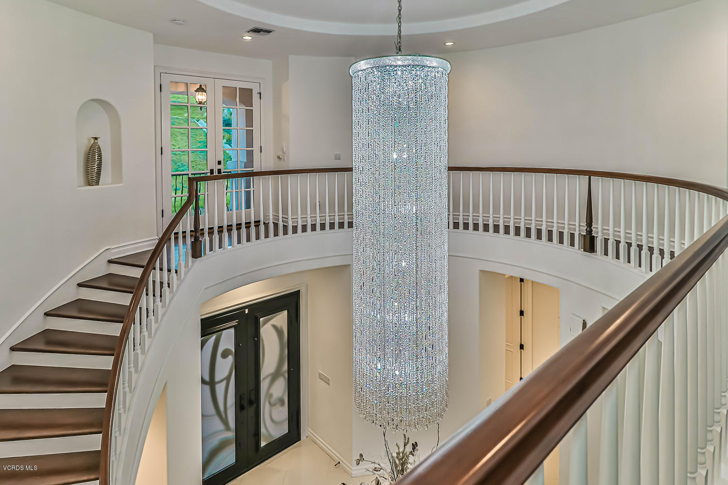 22457 North Summit Ridge Circle Chatsworth, CA 91311 - Photo 28 of 63 a view of staircase with railing and a chandelier