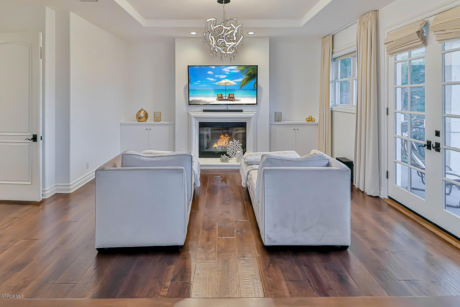 22457 North Summit Ridge Circle Chatsworth, CA 91311 - Photo 32 of 63 a living room with furniture a fireplace and a flat screen tv