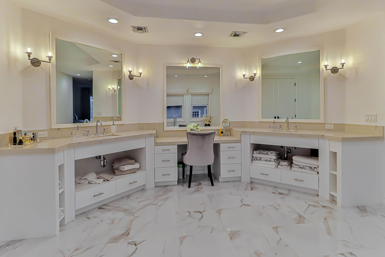 22457 North Summit Ridge Circle Chatsworth, CA 91311 - Photo 39 of 63 a large white kitchen with a stove a sink a table and chairs