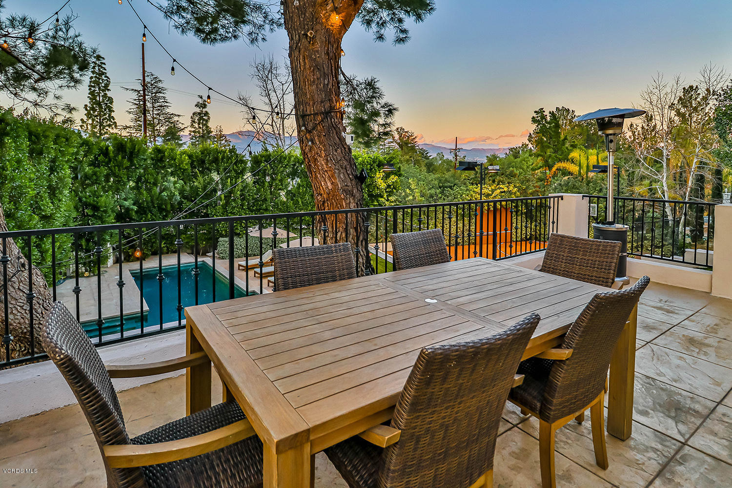22457 North Summit Ridge Circle Chatsworth, CA 91311 - Photo 53 of 63 a view of a roof deck with table and chairs with wooden floor and fence