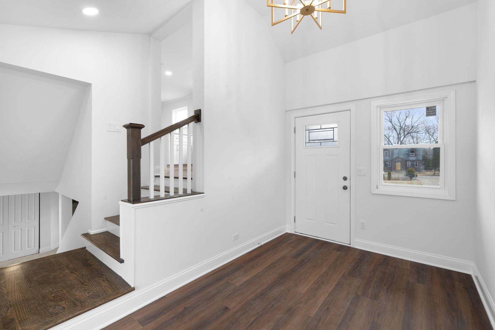 9048 Oneill Drive Burr Ridge, IL 60527 - Photo 4 of 32 a view of a hallway with entryway wooden floor and front door