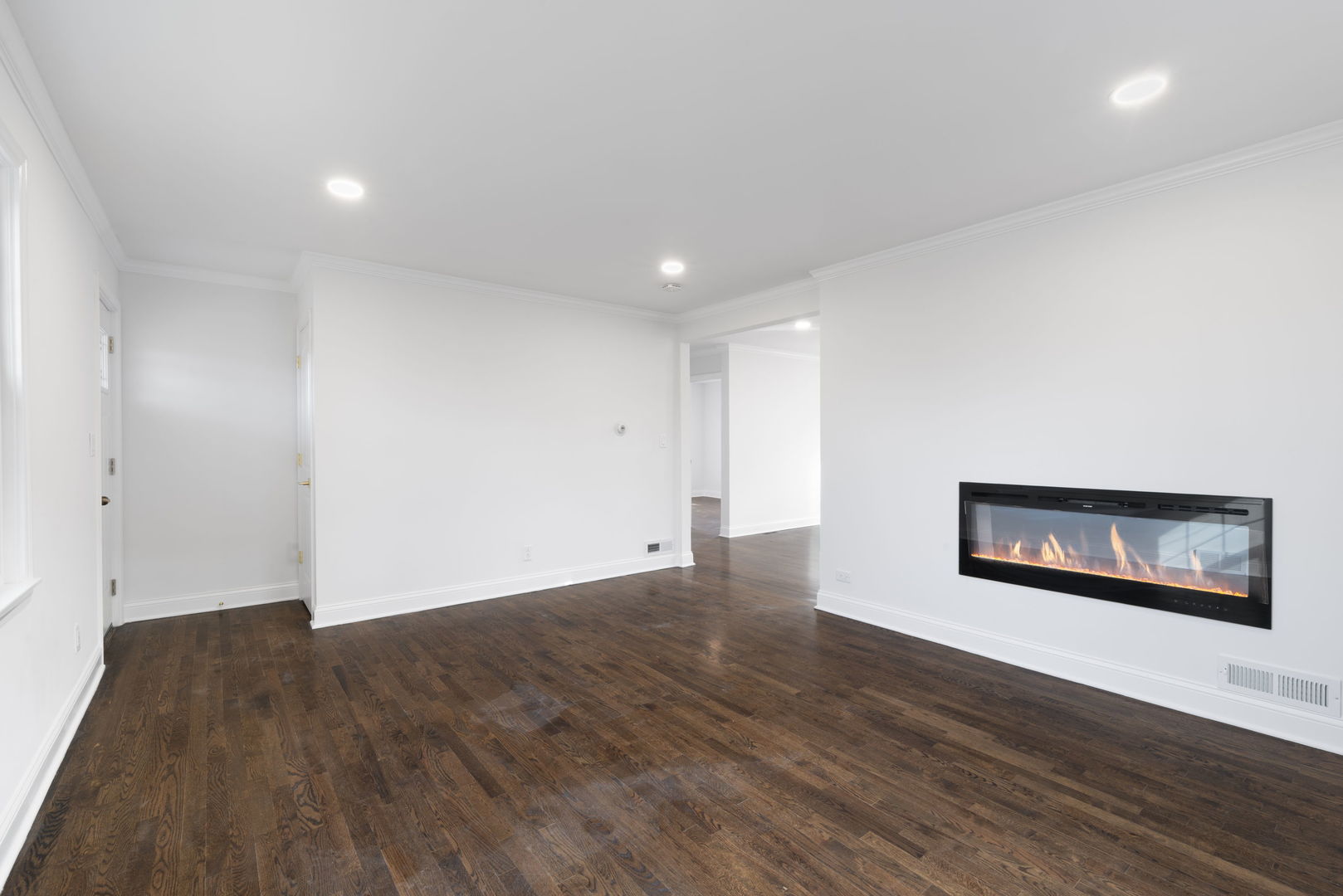 9048 Oneill Drive Burr Ridge, IL 60527 - Photo 7 of 32 a view of an empty room with wooden floor and a painting on the wall
