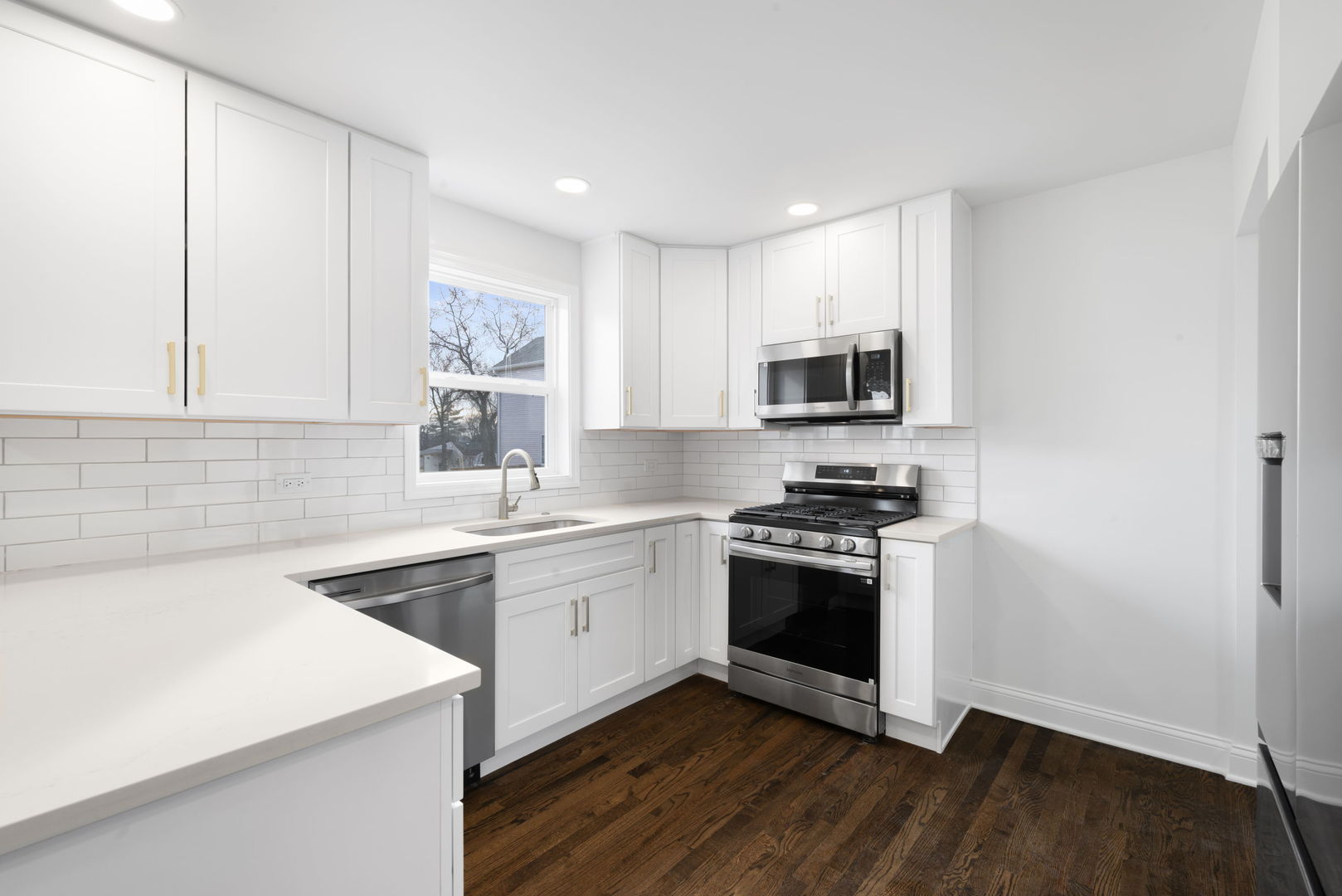 9048 Oneill Drive Burr Ridge, IL 60527 - Photo 10 of 32 a kitchen with stainless steel appliances granite countertop a stove a sink and a microwave
