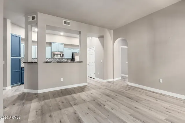 a view of a kitchen with wooden floor and electronic appliances