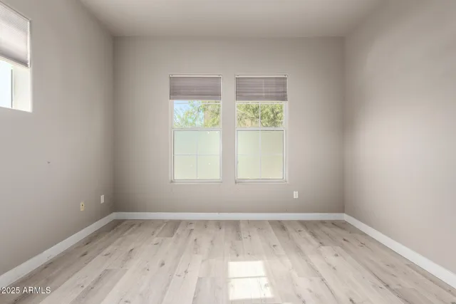 an empty room with wooden floor and closet