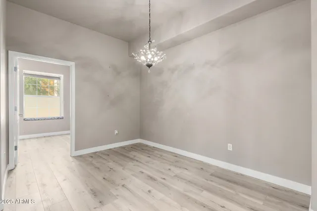 a view of a chandelier fan and wooden floor