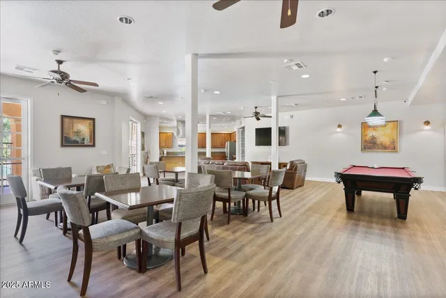 a living room with furniture a flat screen tv and kitchen view