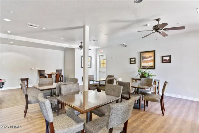 a living room with furniture a ceiling fan and a rug