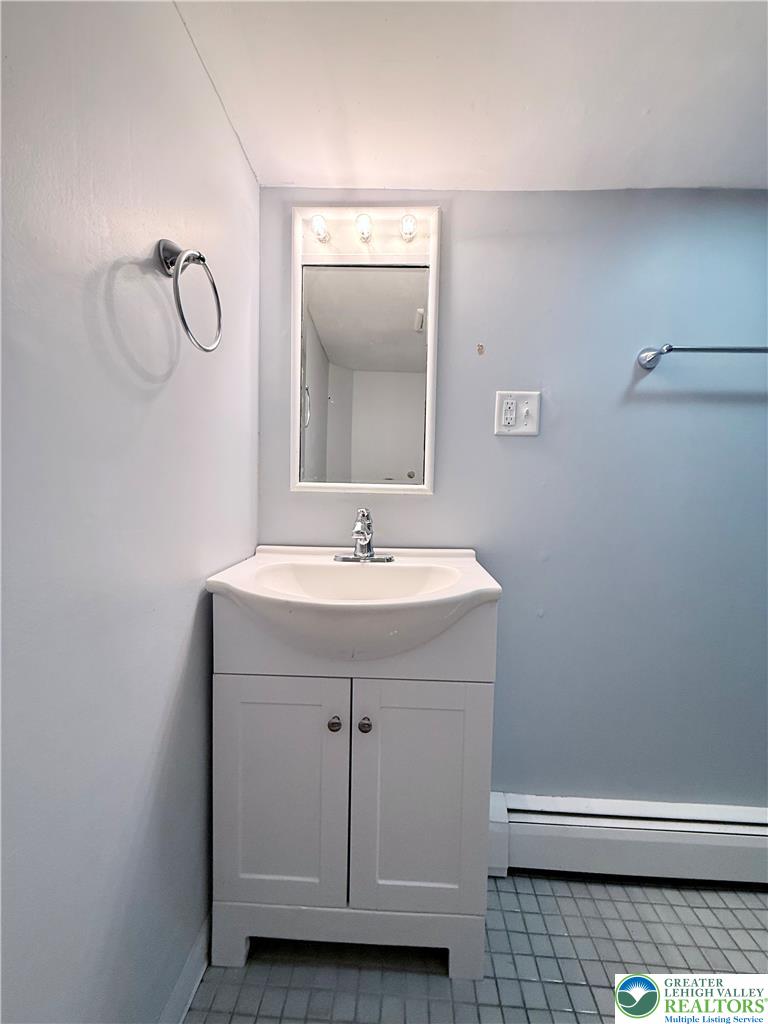 5540 Main Street Whitehall, PA 18052 - Photo 43 of 53 A compact vanity with a clean white cabinet offers practical bathroom storage and a simple basin.
