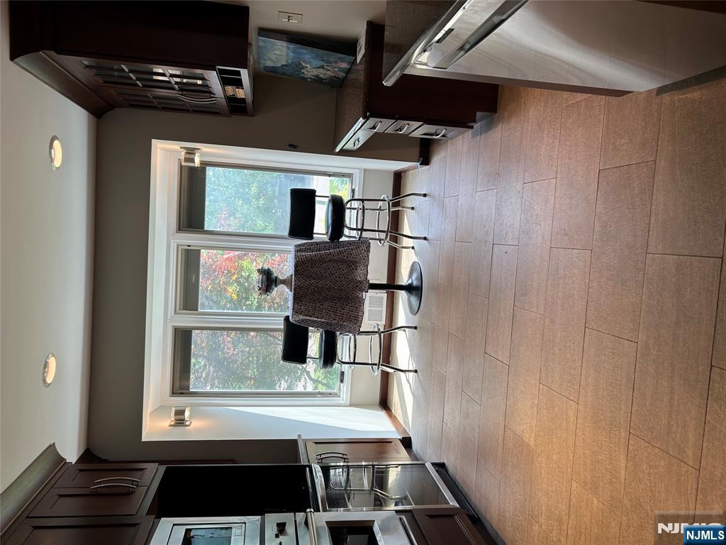 220 Butternut Drive Wayne, NJ 07470 - Photo 11 of 24 a living room with furniture a flat screen tv and a floor to ceiling window
