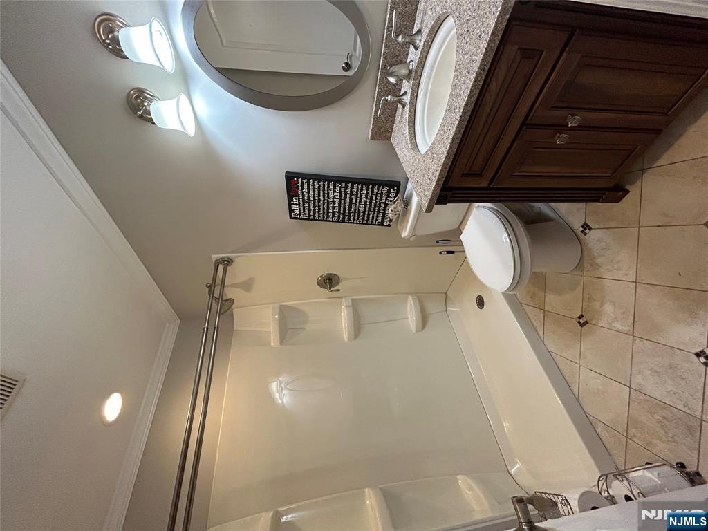 220 Butternut Drive Wayne, NJ 07470 - Photo 20 of 24 a bathroom with a double vanity sink toilet mirror and shower