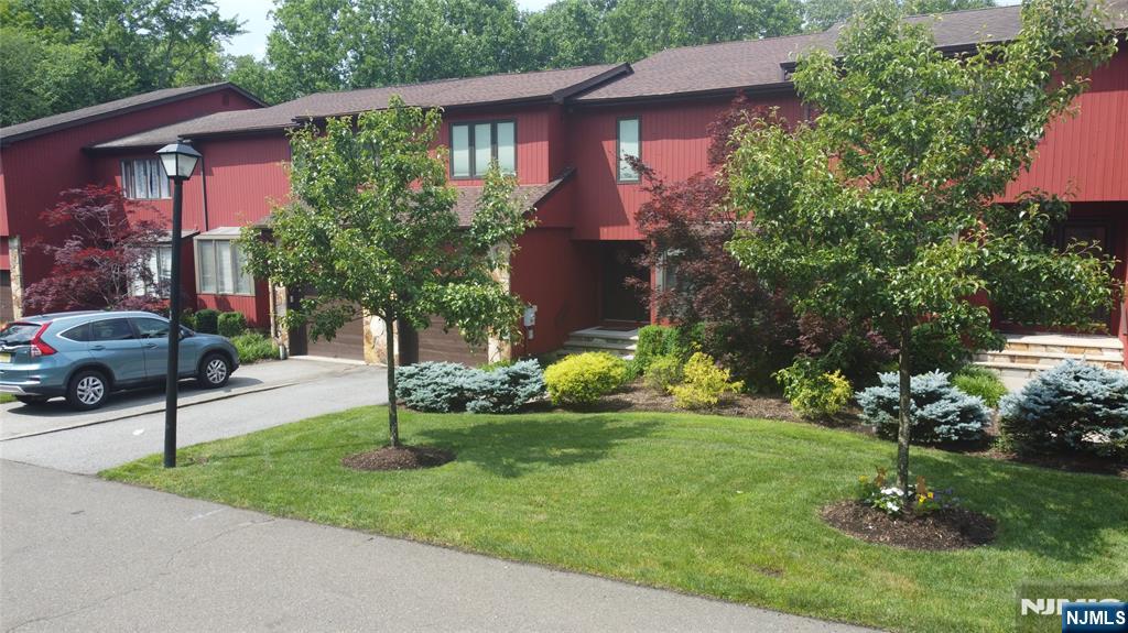 220 Butternut Drive Wayne, NJ 07470 - Photo 7 of 24 a view of a house with a yard and plants
