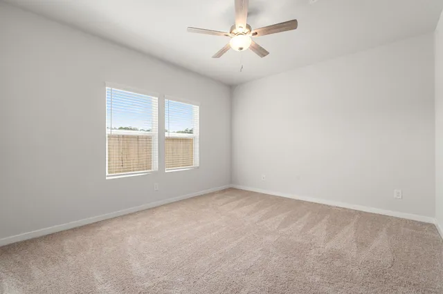a bedroom with a bed and ceiling fan