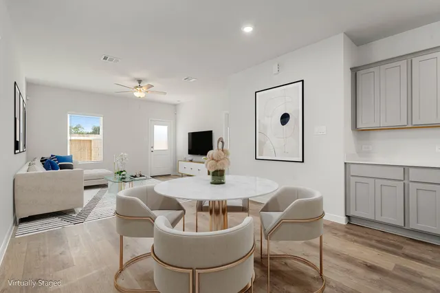 a living room with furniture a wooden floor and sink