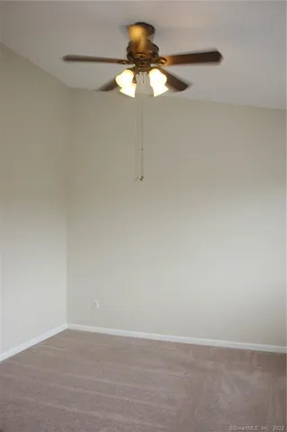 a view of a small space with wooden floor and a chandelier