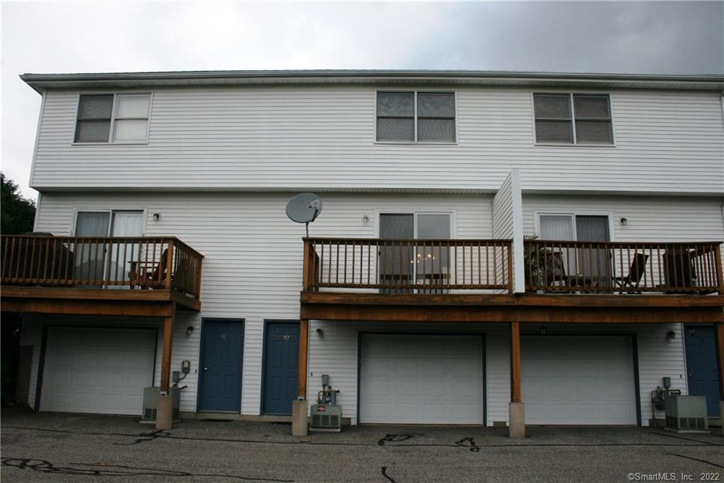 92 Commodore Cmns, Unit 92 Derby, CT 06418 - Photo 3 of 21 a front view of a building with glass windows